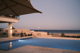 a large swimming pool next to a beach