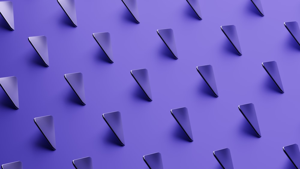 a purple wall with a bunch of metal spikes on it