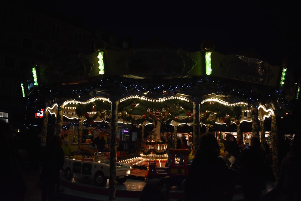 a merry go round is lit up at night