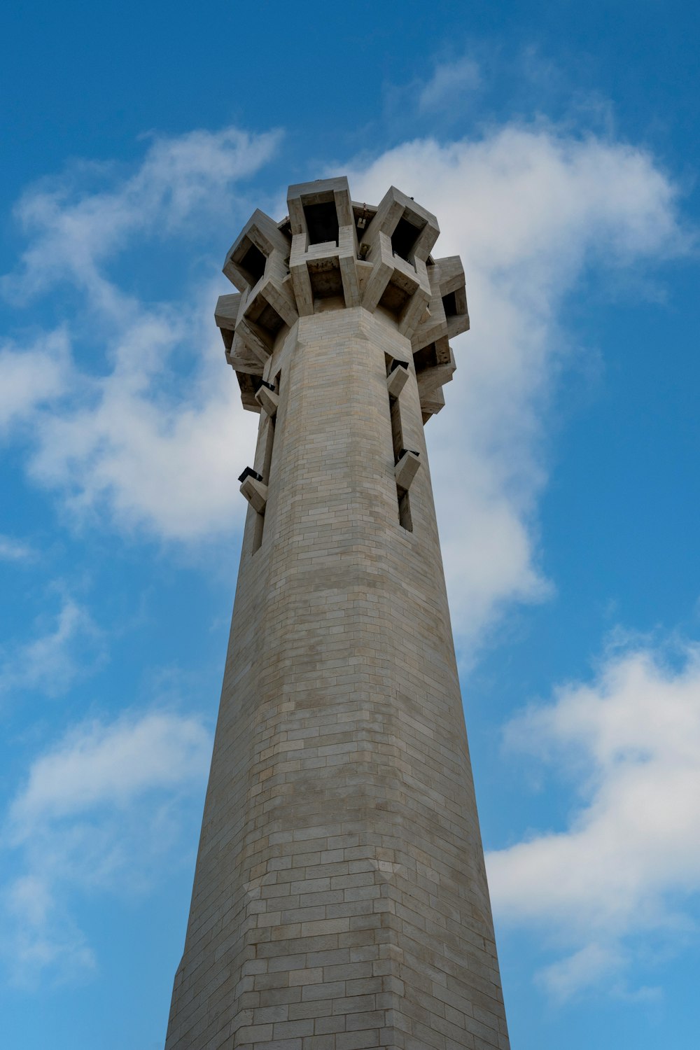 a tall brick tower with a sky background