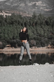 A confident sales representative standing on a mountain trail, overlooking a vast forested valley at sunrise.