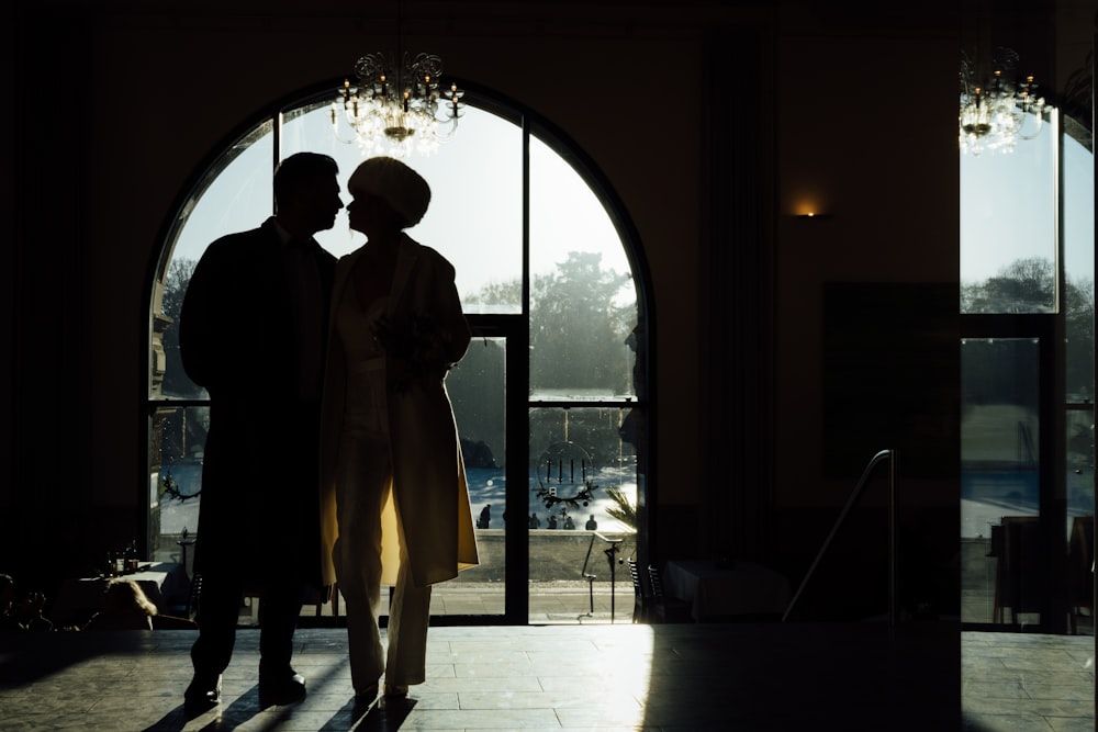 a man and a woman standing in front of a doorway