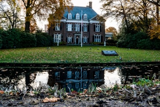 Timeless brick manor surrounded by mature trees and elegant landscaping.