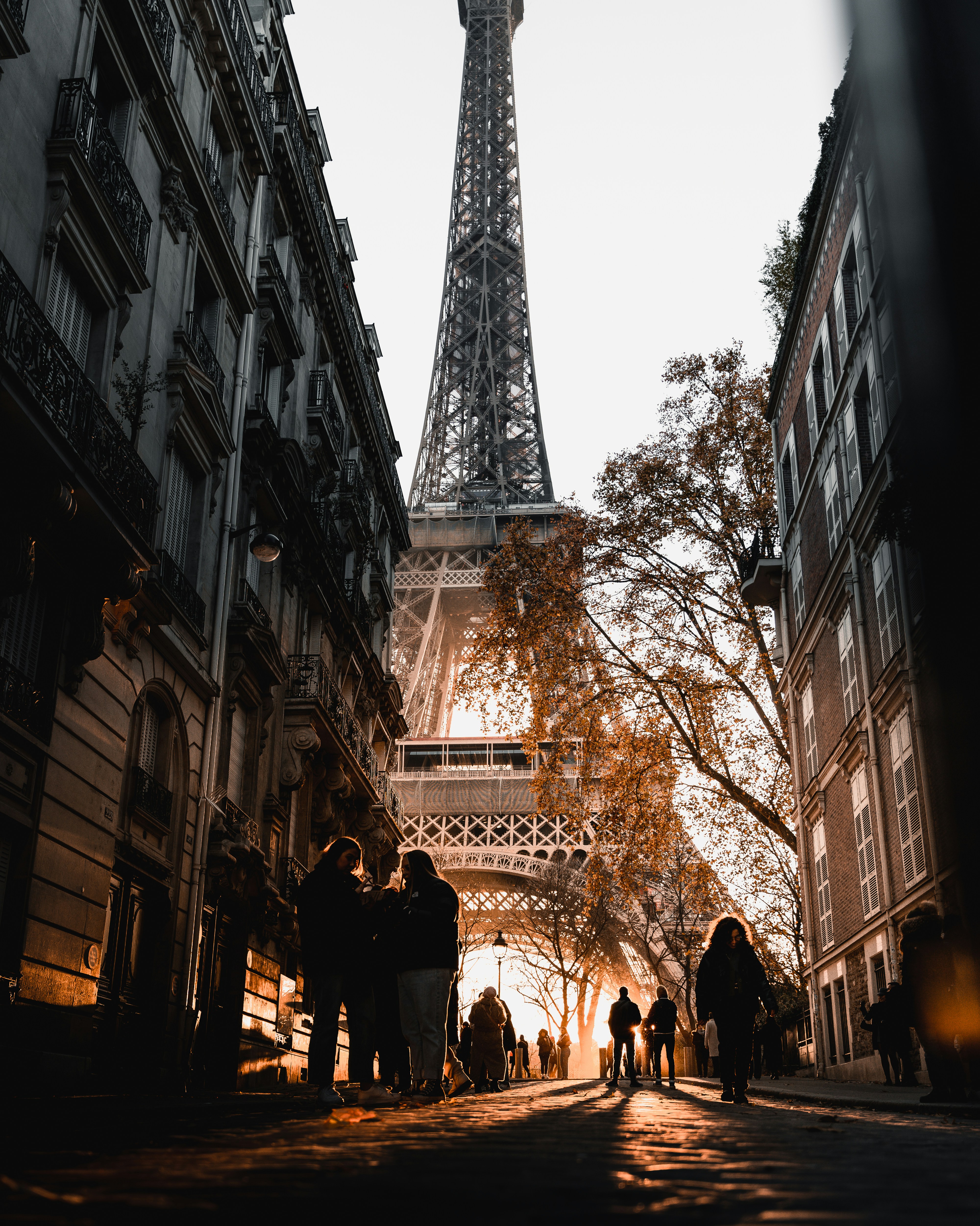 a group of people standing in front of the eiffel tower