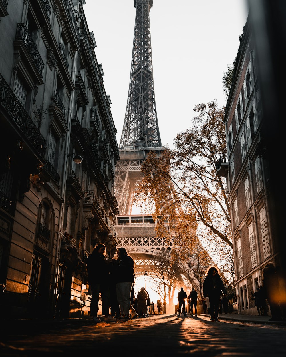 a group of people standing in front of the eiffel tower