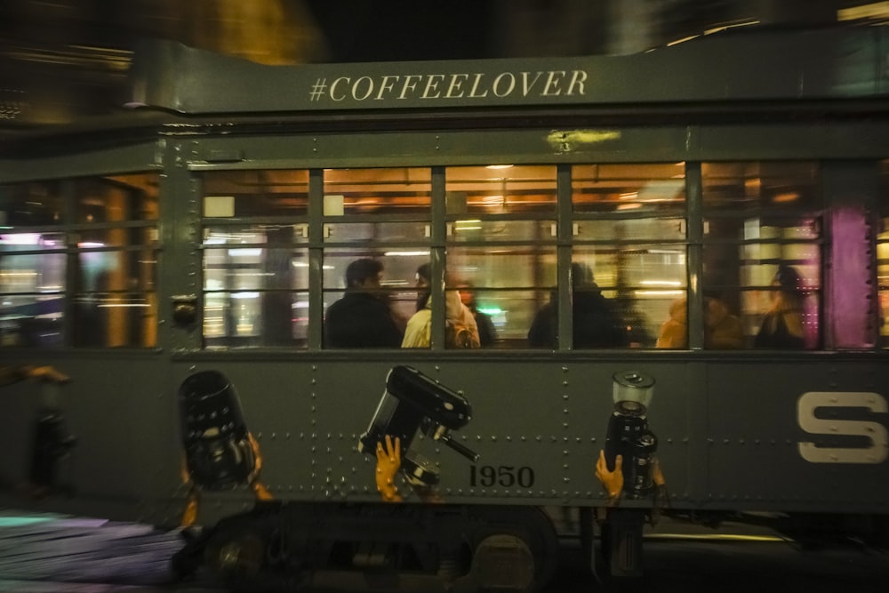 a train car with people in it driving down the street