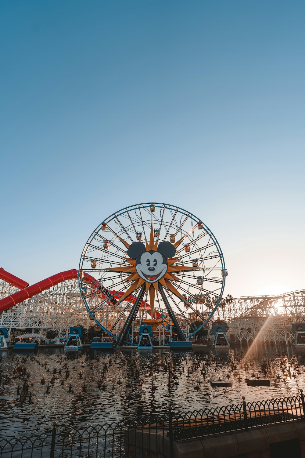 a large ferris wheel sitting next to a body of water