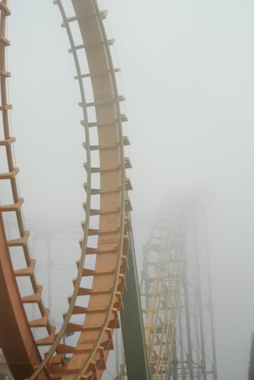 a roller coaster in the middle of a foggy day