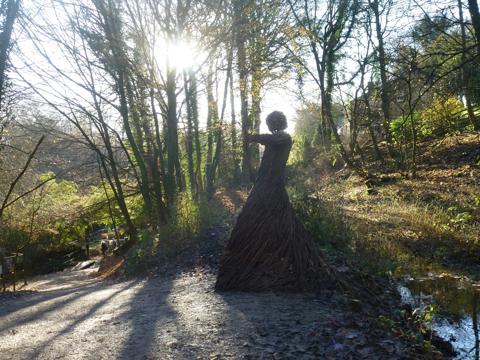 An outdoor installation of a large-scale kinetic sculpture interacting with natural light and shadows.