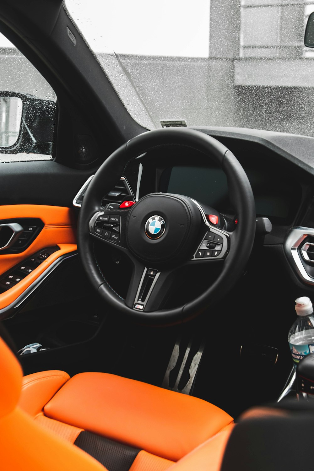 the interior of a car with orange leather seats