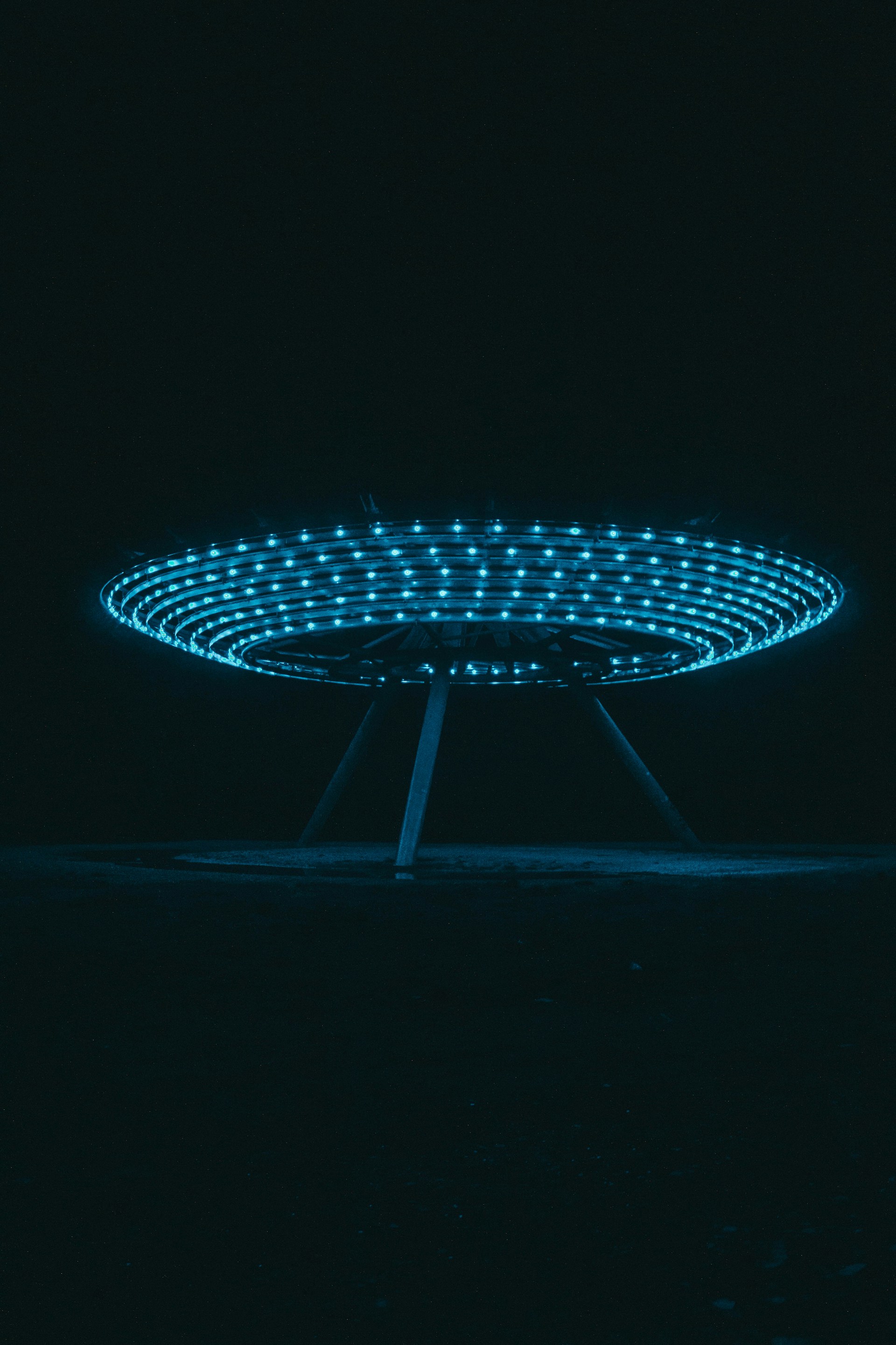 a circular object with blue lights in the dark