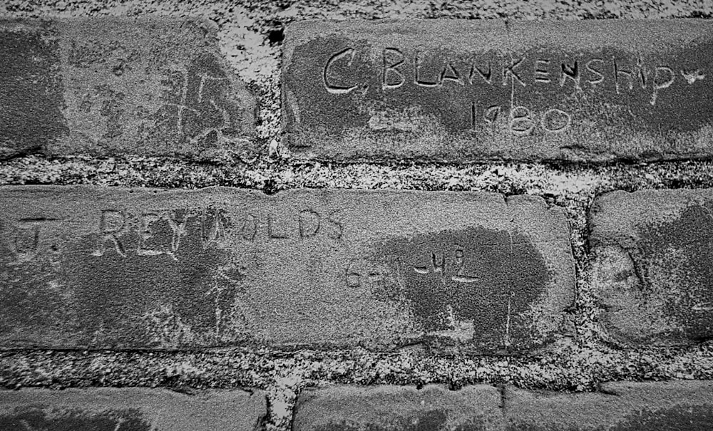 a brick wall with graffiti written on it