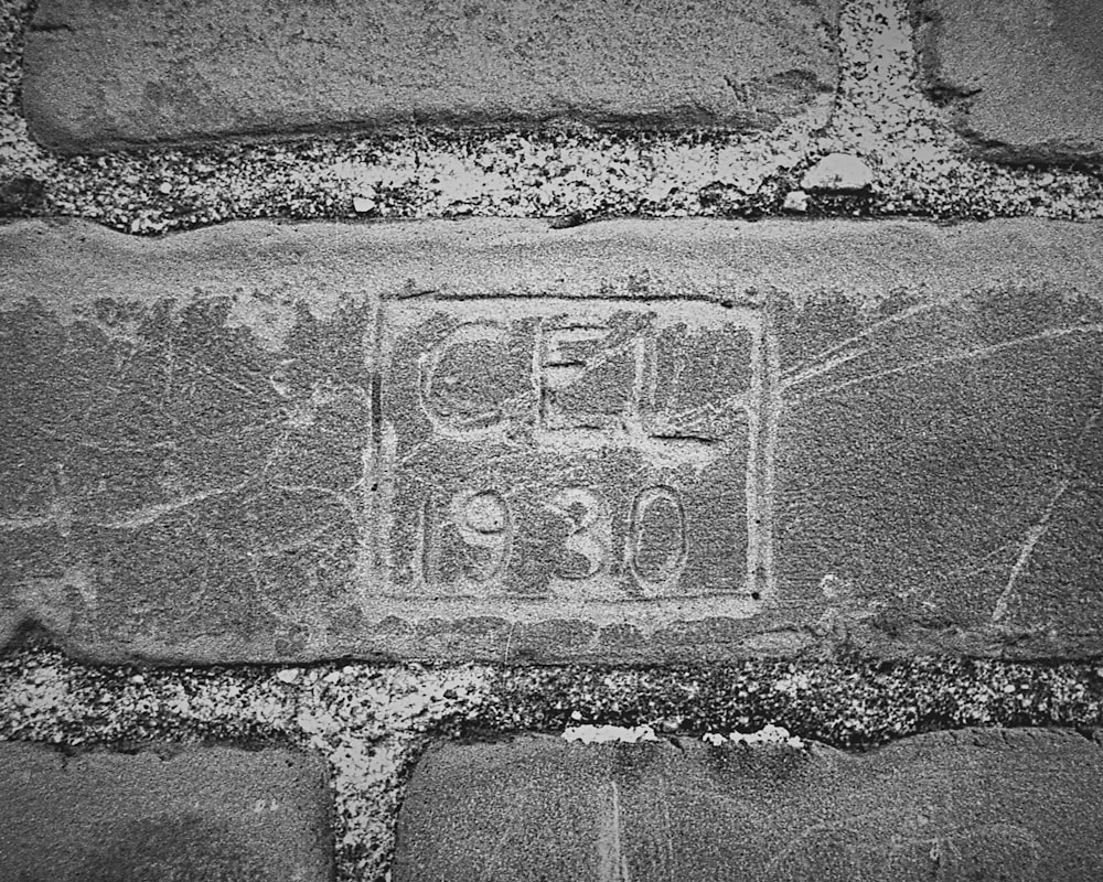 a black and white photo of a brick wall