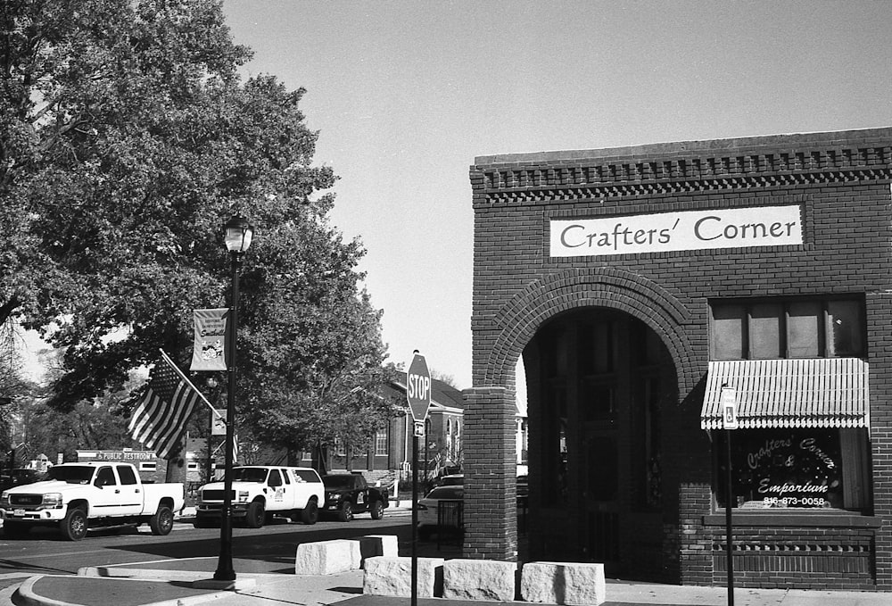 a black and white photo of a street corner