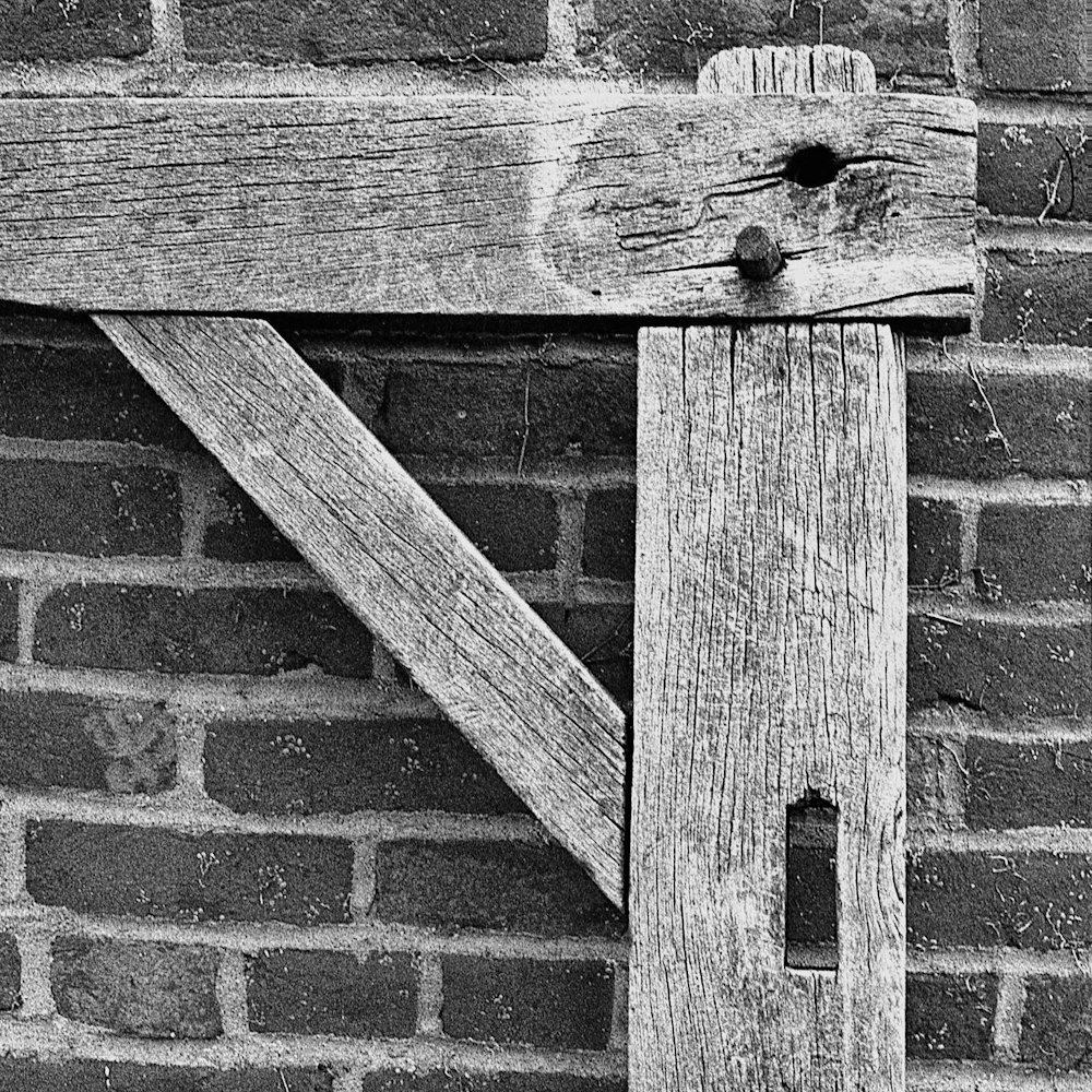 a close up of a wooden door on a brick wall