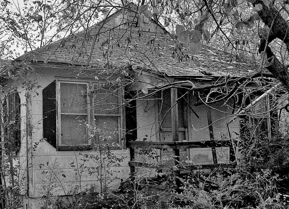 a black and white photo of an old house