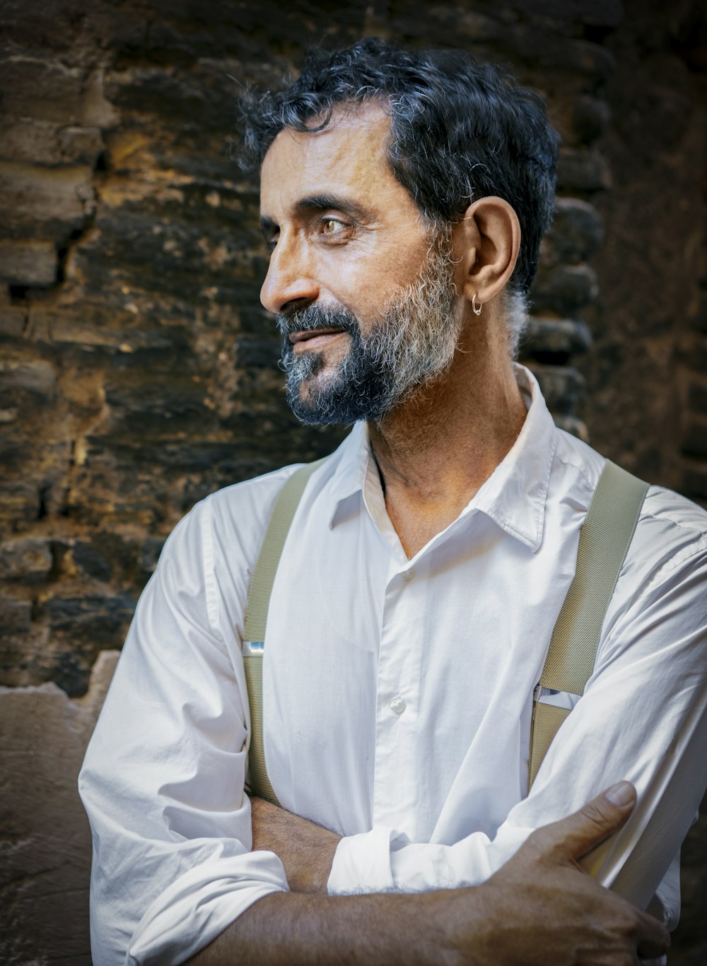 a man wearing suspenders and a white shirt