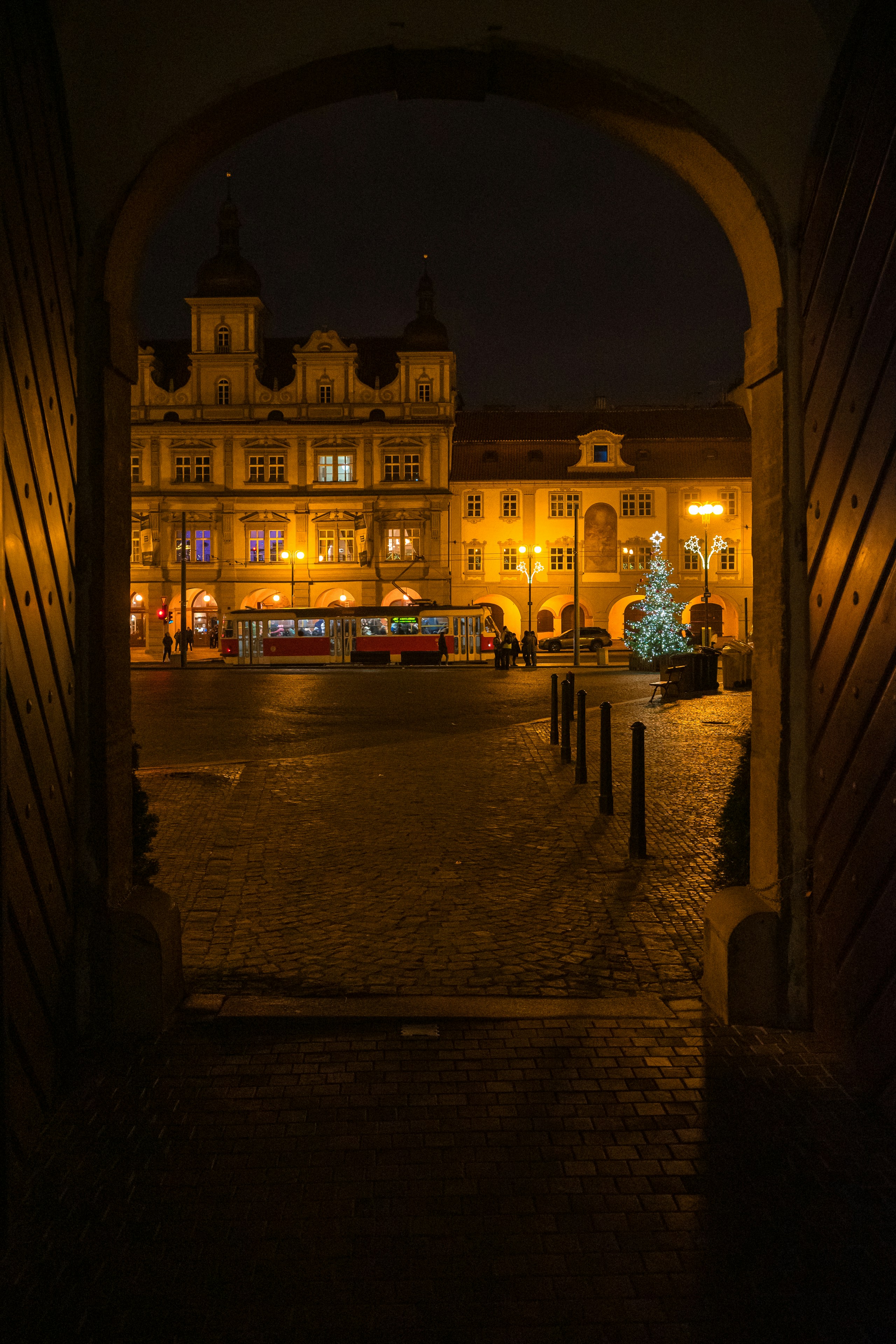 a large building with a lit up christmas tree in the middle of it