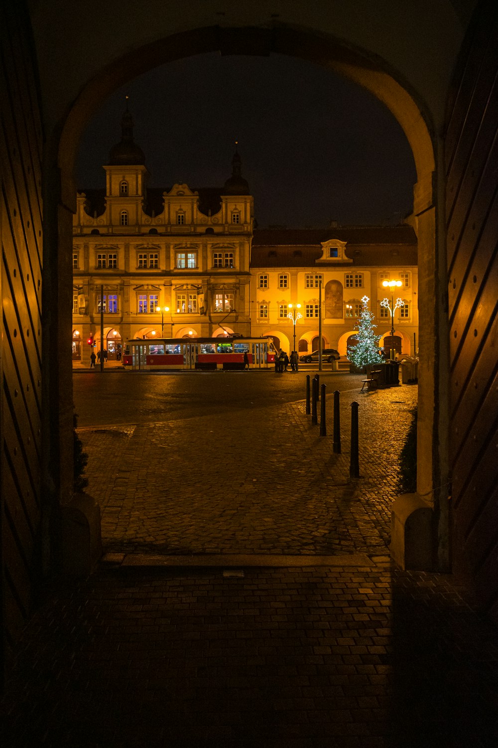 a large building with a lit up christmas tree in the middle of it