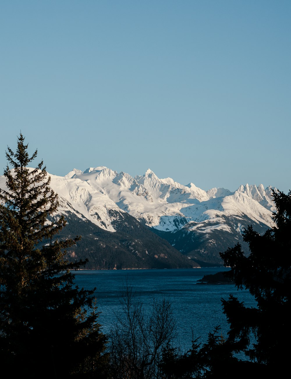 a view of a mountain range with a lake in the foreground