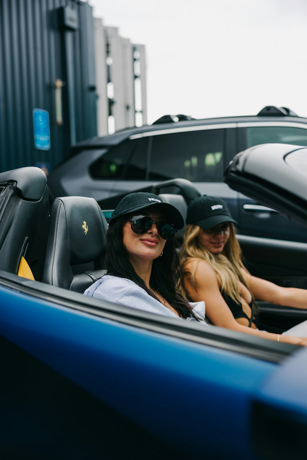 two beautiful women sitting in a convertible car