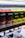 Rows of canned beverages displayed on a shelf, featuring branding that includes the words 'Drippy' and 'cannabis infused'. The cans are predominantly in red and yellow colors with black and white text. The background includes blurred shelves and packaging.