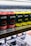 Rows of canned beverages displayed on a shelf, featuring branding that includes the words 'Drippy' and 'cannabis infused'. The cans are predominantly in red and yellow colors with black and white text. The background includes blurred shelves and packaging.
