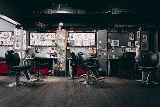 a barber shop with chairs and posters on the wall