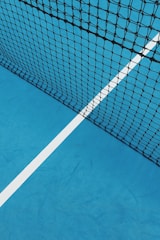 a blue tennis court with a white line on it