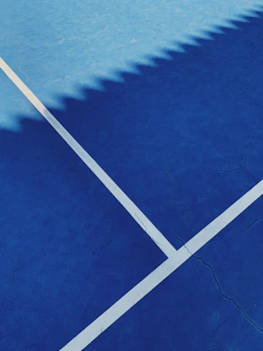 Close-up of premium acrylic coating on a tennis court surface.