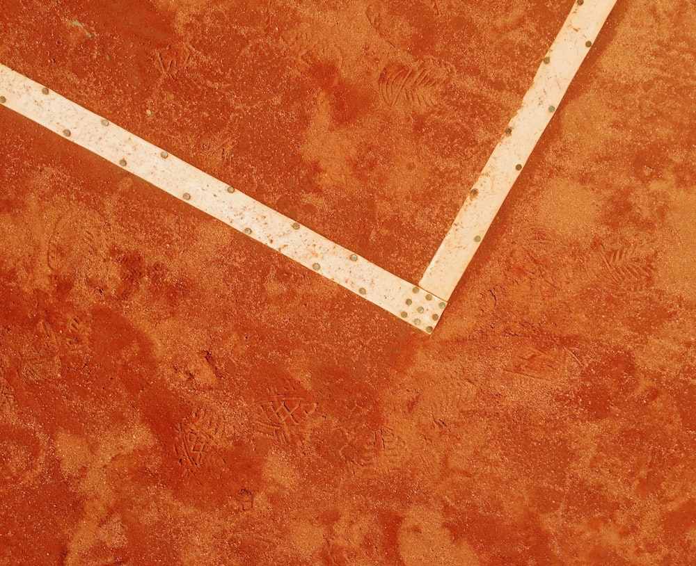 a tennis racket laying on a tennis court