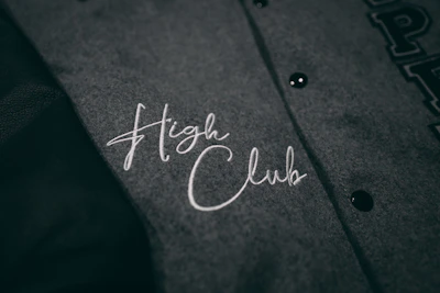 Close-up of a vibrant custom club hoodie with bold logo embroidery.