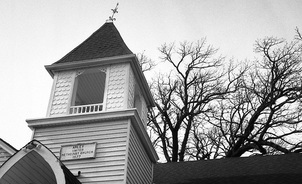 a black and white photo of a church steeple