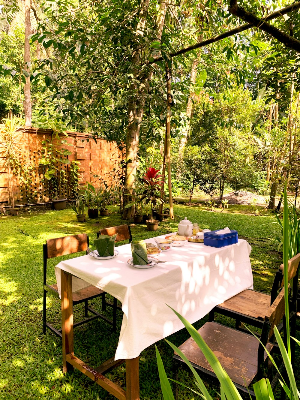 a picnic table in the middle of a garden