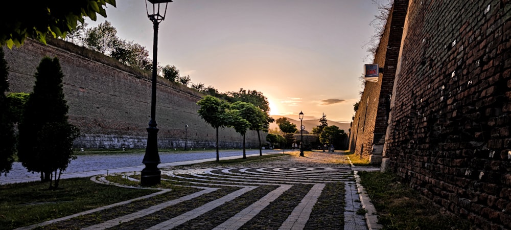 a cobblestone street with a clock tower in the background