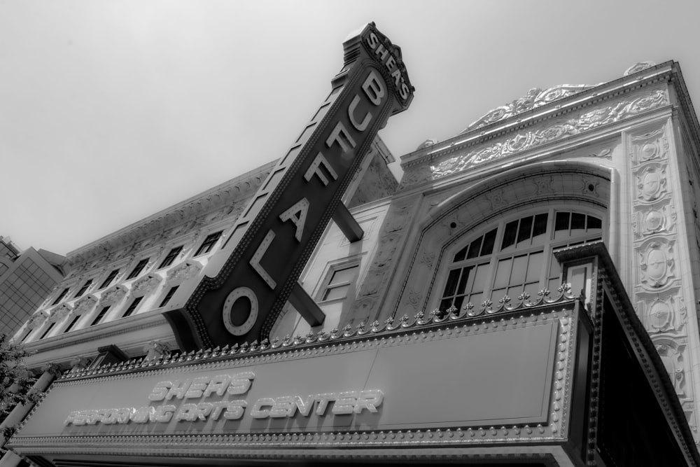 a black and white photo of a theater sign