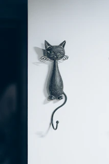 A minimalist wall-mounted cat shelf in matte black finish, perfect for urban apartments with limited space.