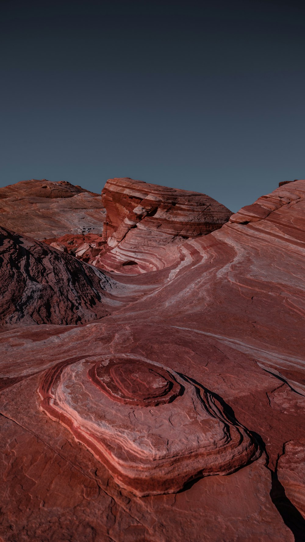 a red rock formation with a blue sky in the background