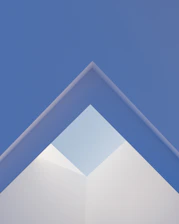 Abstract geometric shapes in blue and gray tones representing clarity and structure.