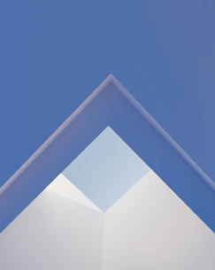 Abstract geometric shapes in blue and gray tones representing clarity and structure.
