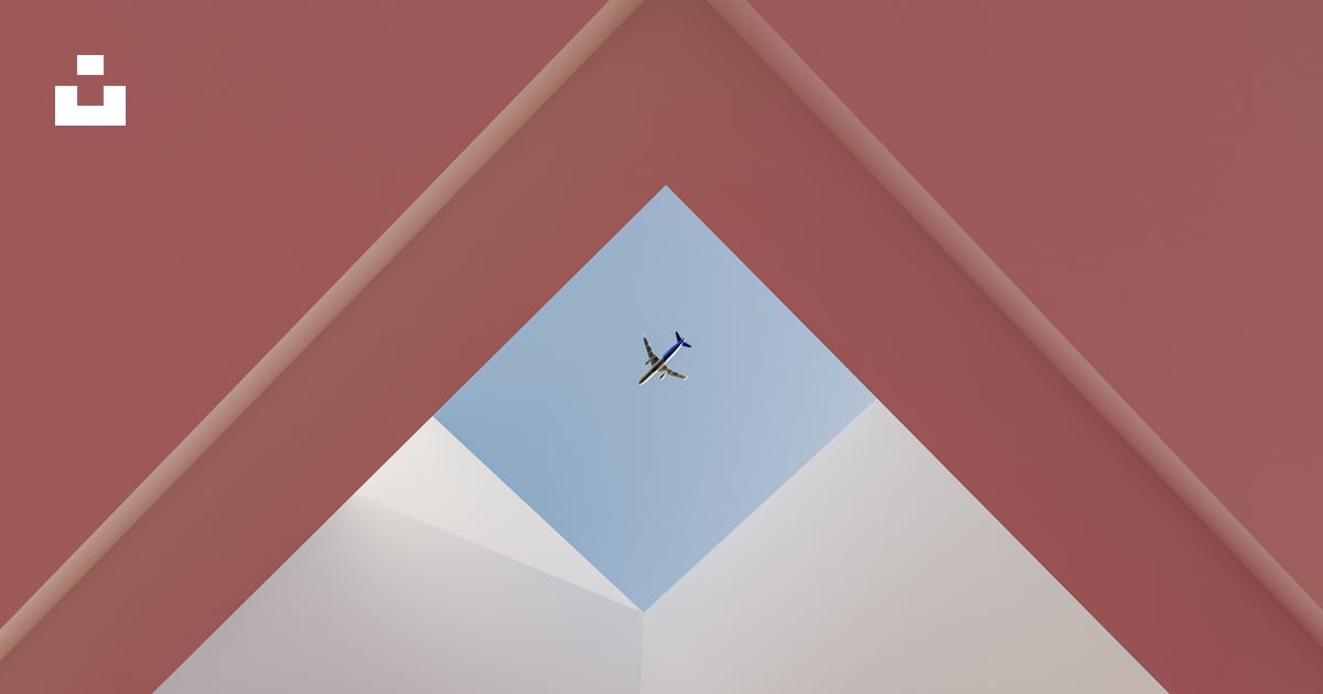 An airplane flying in the sky through a triangle photo – Free Triangle ...