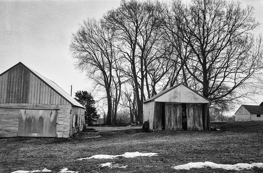 a black and white photo of an old barn