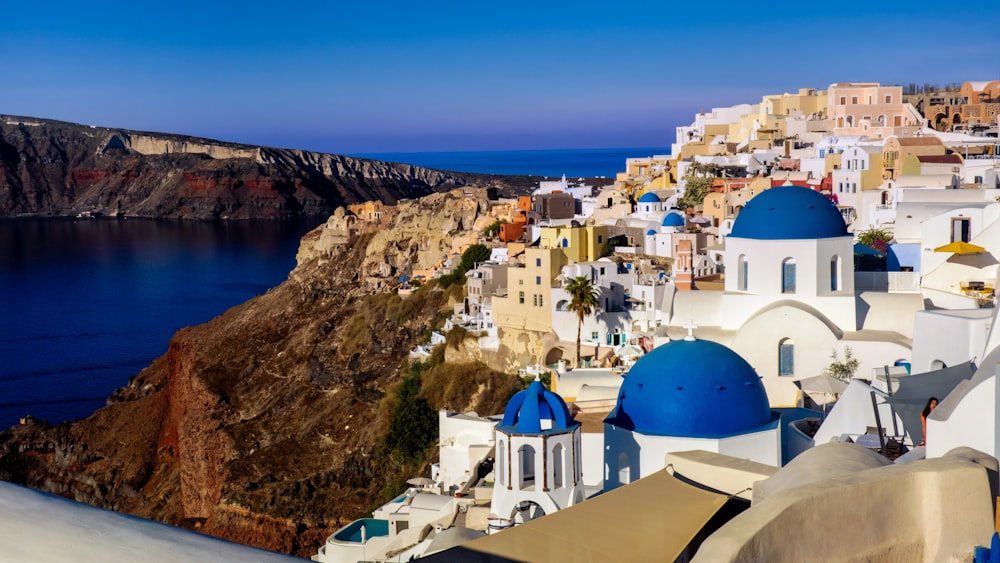 a scenic view of a town on the edge of a cliff