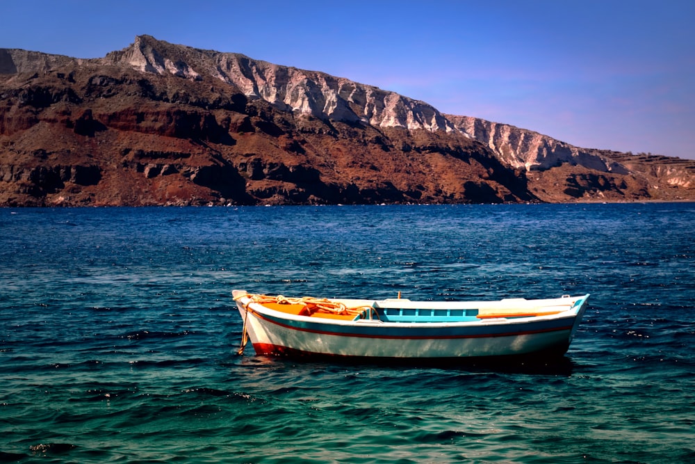 a small boat floating on top of a body of water