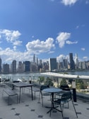 Spacious outdoor terrace with cityscape view at sunset.