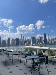 Chic outdoor terrace overlooking a serene cityscape at dusk.