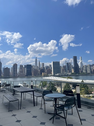 Spacious outdoor terrace with cityscape view at sunset.