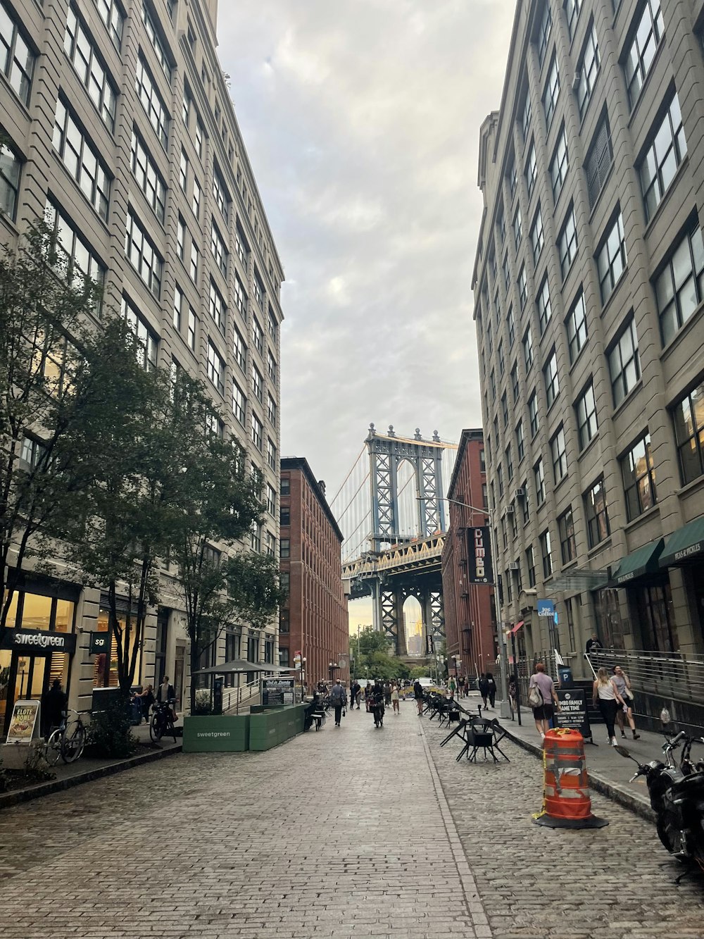 a city street with a bridge in the background