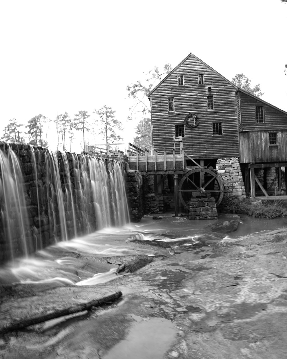 a black and white photo of a water mill