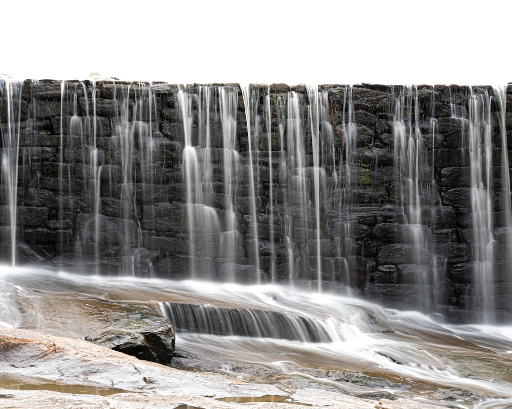 a large waterfall with water cascading down it's sides